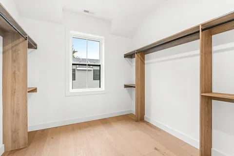 a bathroom with a tub shower sink and mirror