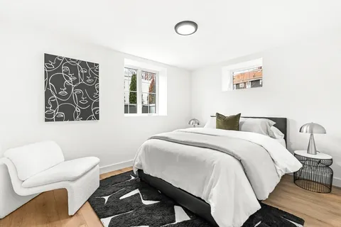 a living room with furniture and view of kitchen