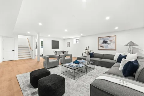 a living room with furniture and a painting