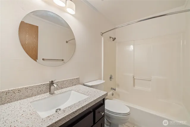 a bathroom with a sink a toilet and a mirror