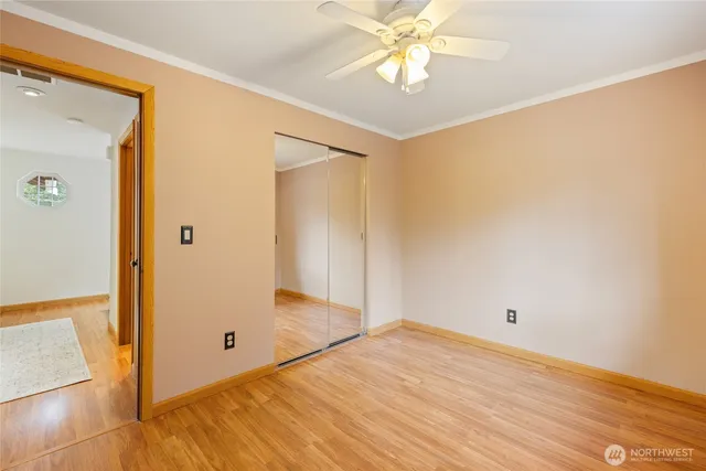 a view of empty room with wooden floor