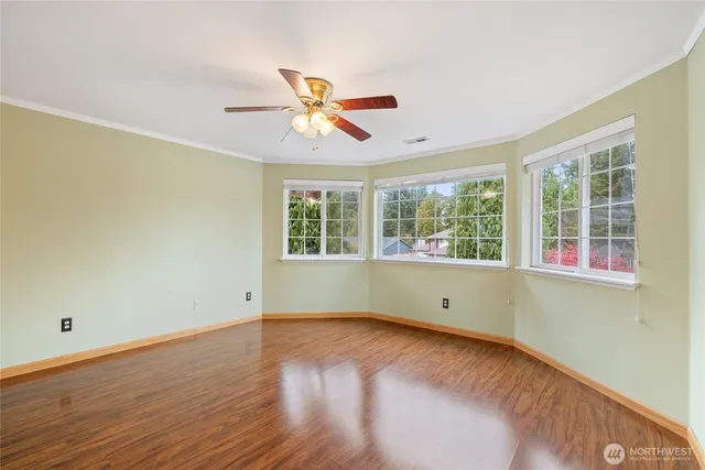 a view of room with wooden floor and fan