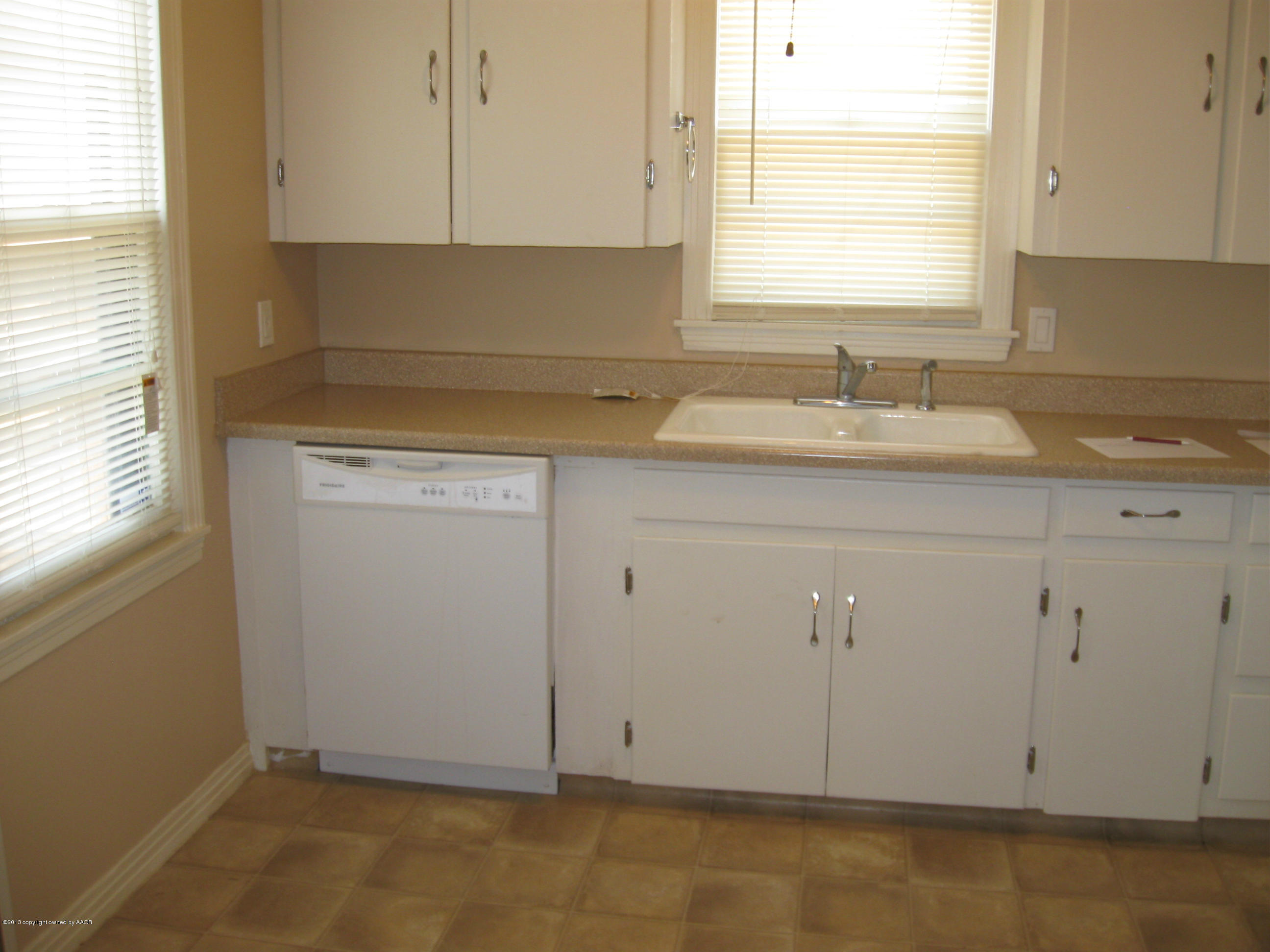 4410 South Lipscomb Street Amarillo, TX 79110 - Photo 16 of 19 a kitchen with a sink cabinets and window