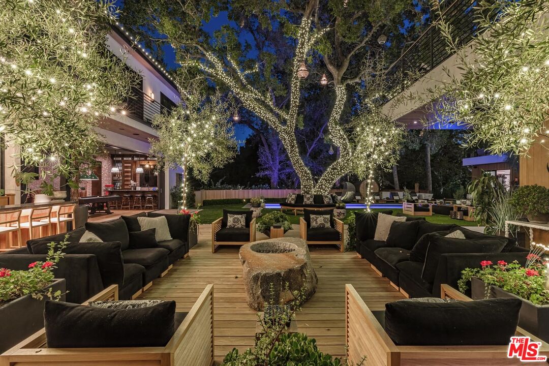 3904 Valley Meadow Road Encino, CA 91436 - Photo 12 of 27 a view of a patio with couches table and chairs and potted plants