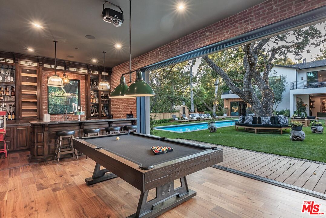 3904 Valley Meadow Road Encino, CA 91436 - Photo 13 of 27 a view of a patio with a table chairs and a backyard