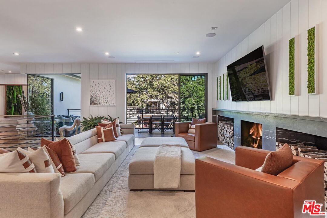 3904 Valley Meadow Road Encino, CA 91436 - Photo 16 of 27 a living room with fireplace furniture and a flat screen tv