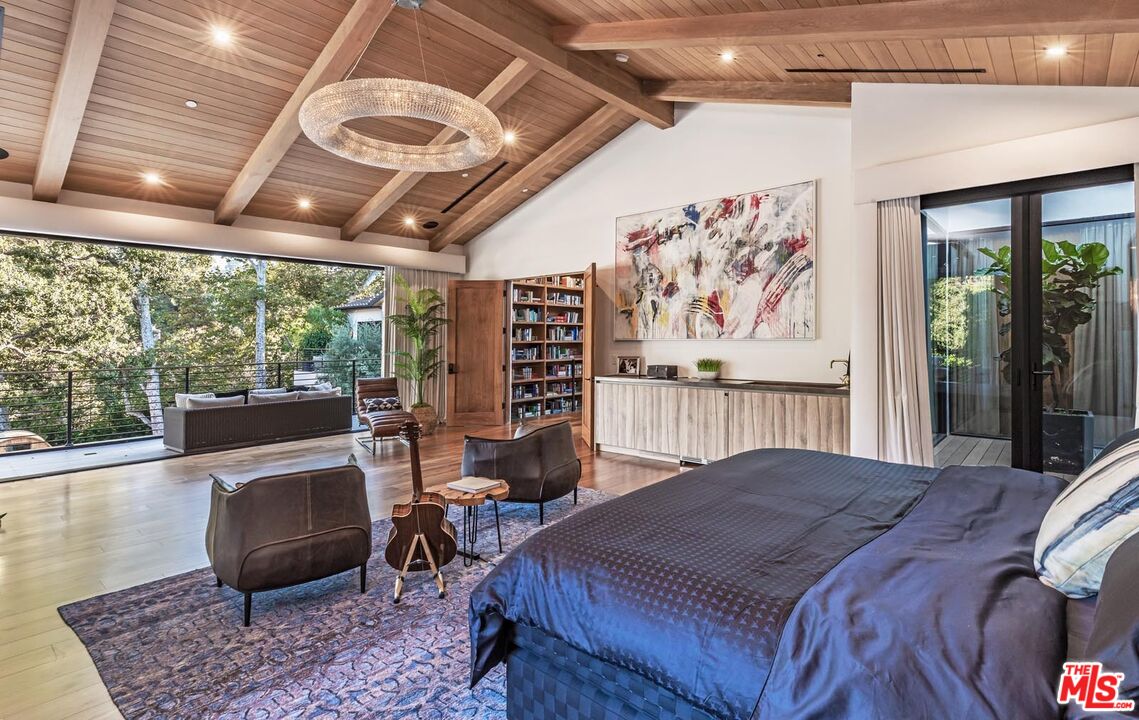 3904 Valley Meadow Road Encino, CA 91436 - Photo 18 of 27 a bed room with a bed and a large window