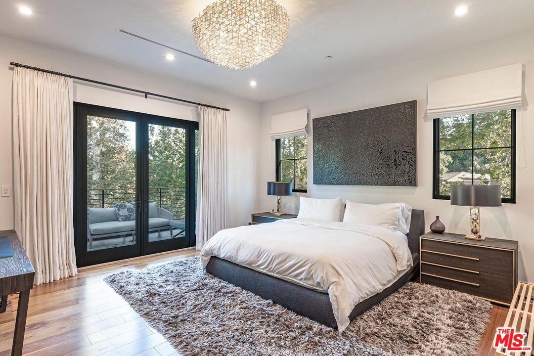 3904 Valley Meadow Road Encino, CA 91436 - Photo 20 of 27 a bedroom with a large bed and a large window