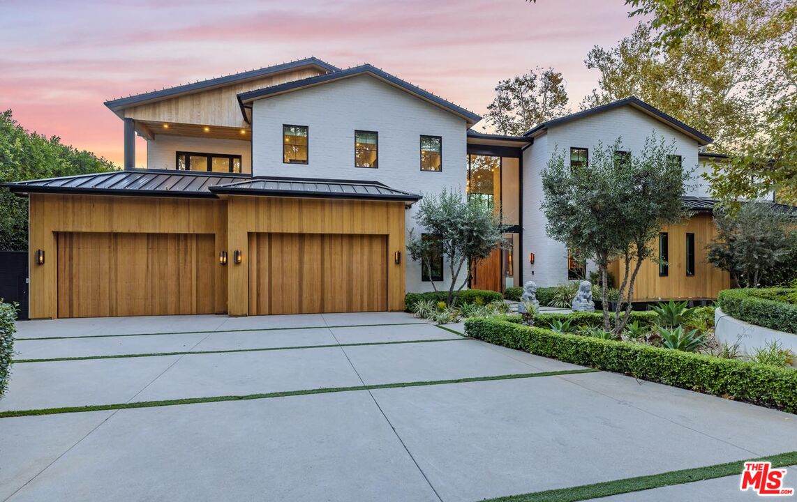 3904 Valley Meadow Road Encino, CA 91436 - Photo 2 of 27 a front view of a house with a yard and garage