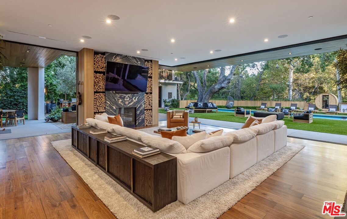 3904 Valley Meadow Road Encino, CA 91436 - Photo 7 of 27 a living room with fireplace furniture and a large window