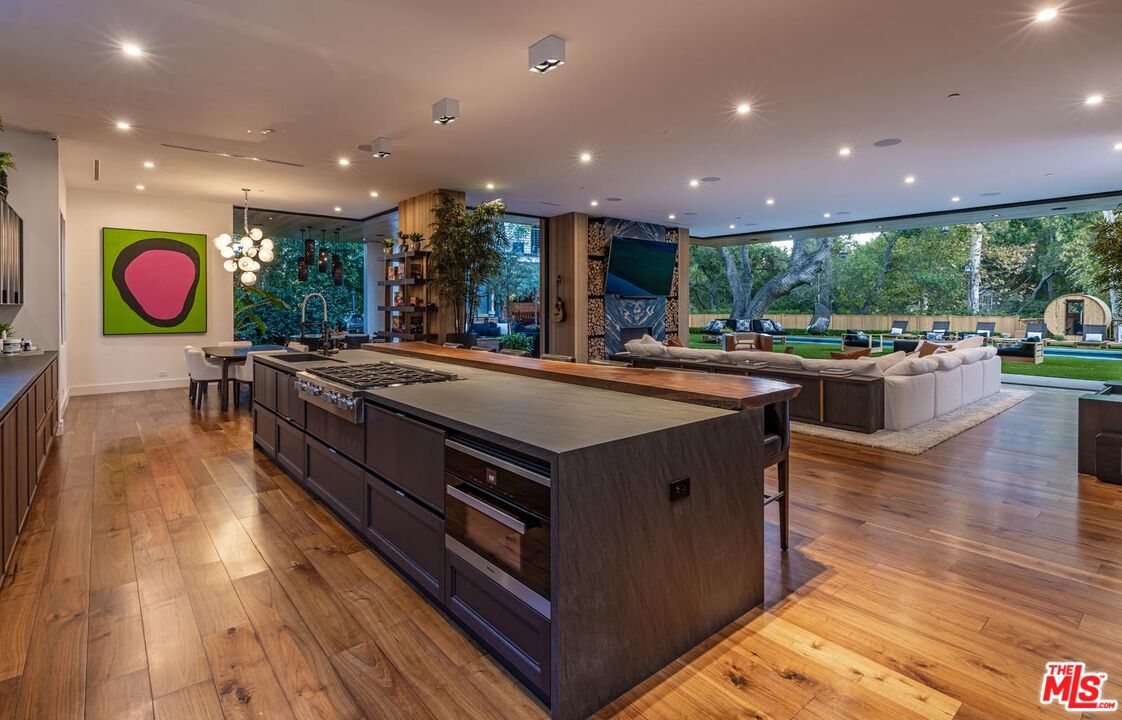 3904 Valley Meadow Road Encino, CA 91436 - Photo 10 of 27 a kitchen with stainless steel appliances granite countertop a large stove a sink and a large island