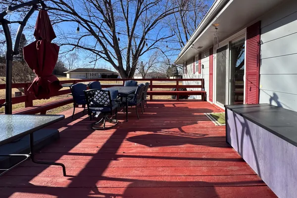 a bedroom with a bed and a chandelier fan