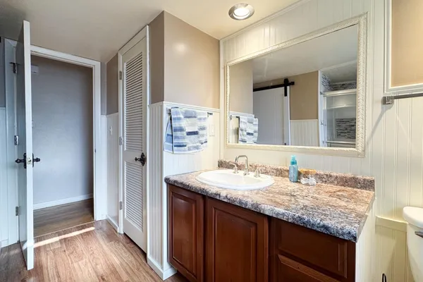 a view of a room with wooden floor and windows