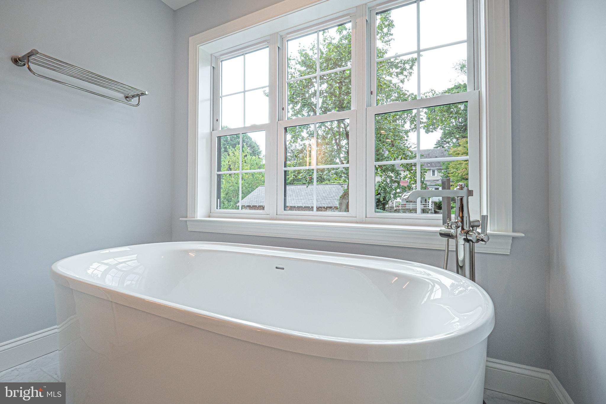 5 Timber Mill Lane, Unit BISCOTTO Landenberg, PA 19350 - Photo 56 of 70 a white bath tub sitting in a bathroom next to a window