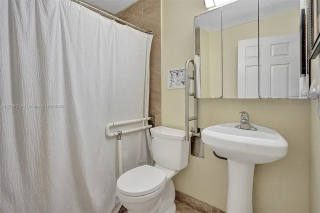 a kitchen with granite countertop wooden cabinets and white appliances