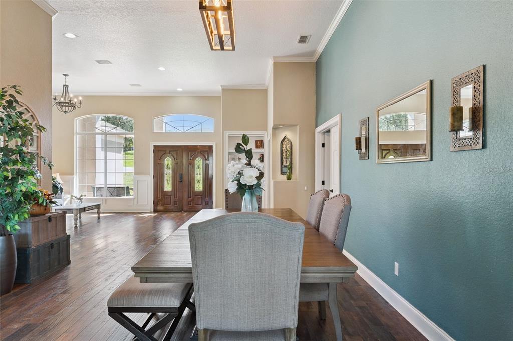 12736 Lake Ridge Circle Clermont, FL 34711 - Photo 11 of 56 a dining room with furniture and wooden floor