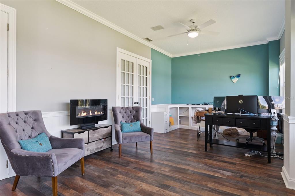 12736 Lake Ridge Circle Clermont, FL 34711 - Photo 18 of 56 a living room with furniture and a flat screen tv