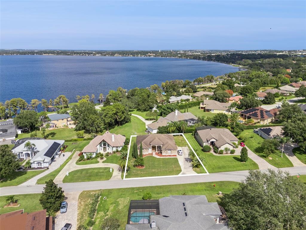 12736 Lake Ridge Circle Clermont, FL 34711 - Photo 2 of 56 an aerial view of residential houses with outdoor space and ocean view