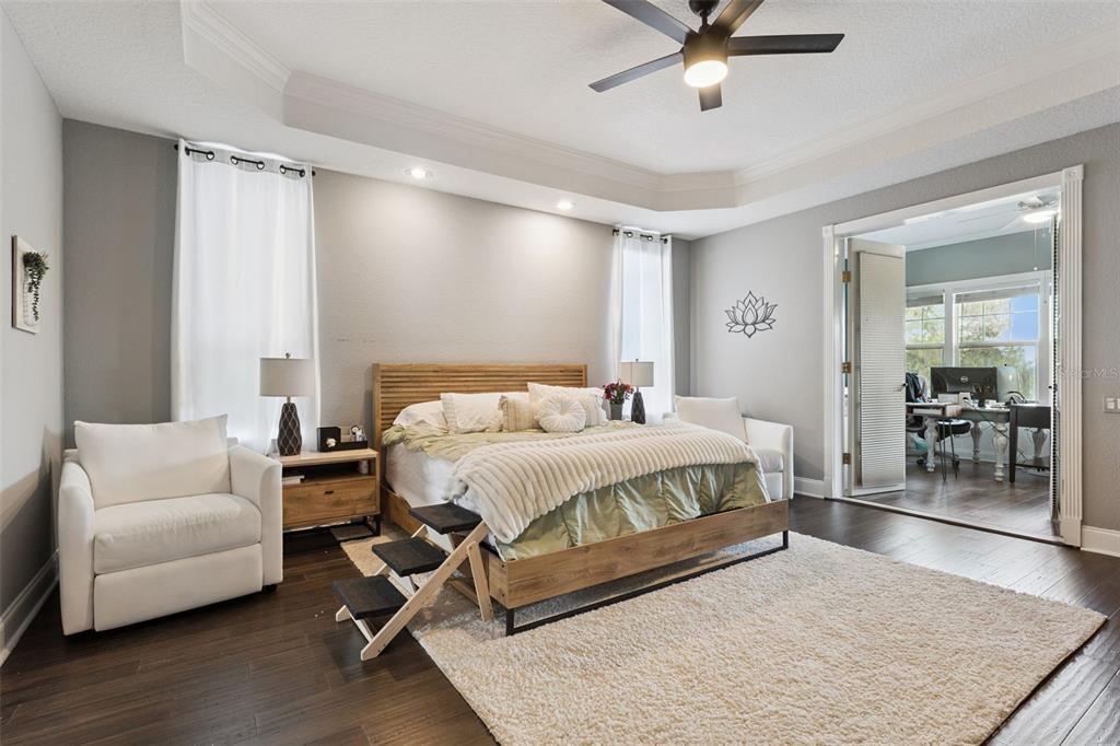 12736 Lake Ridge Circle Clermont, FL 34711 - Photo 23 of 56 a spacious bedroom with a bed and a couch