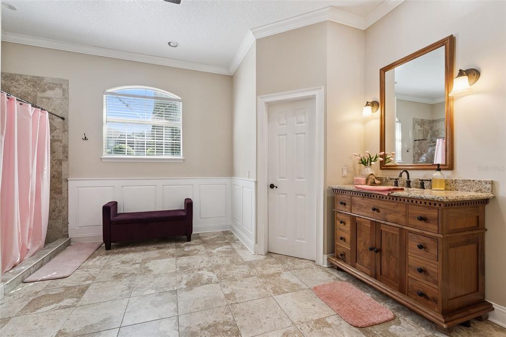 12736 Lake Ridge Circle Clermont, FL 34711 - Photo 27 of 56 a spacious bathroom with a double vanity sink a mirror and a