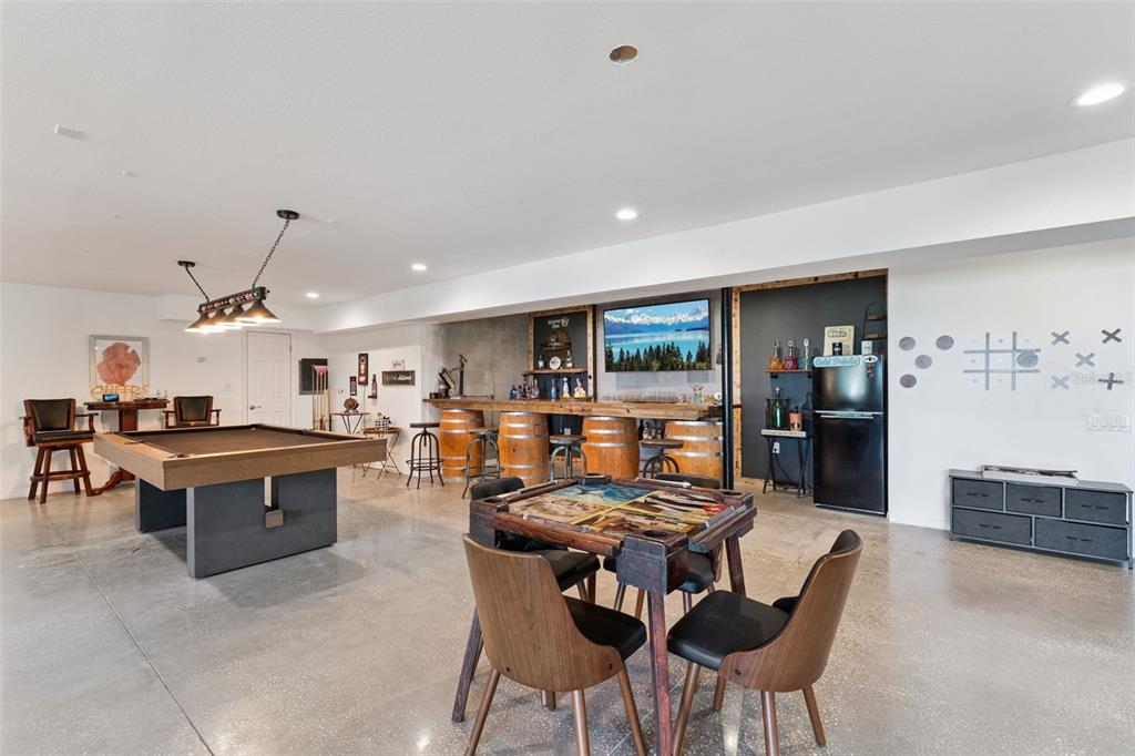 12736 Lake Ridge Circle Clermont, FL 34711 - Photo 36 of 56 a living room with furniture a rug and kitchen view