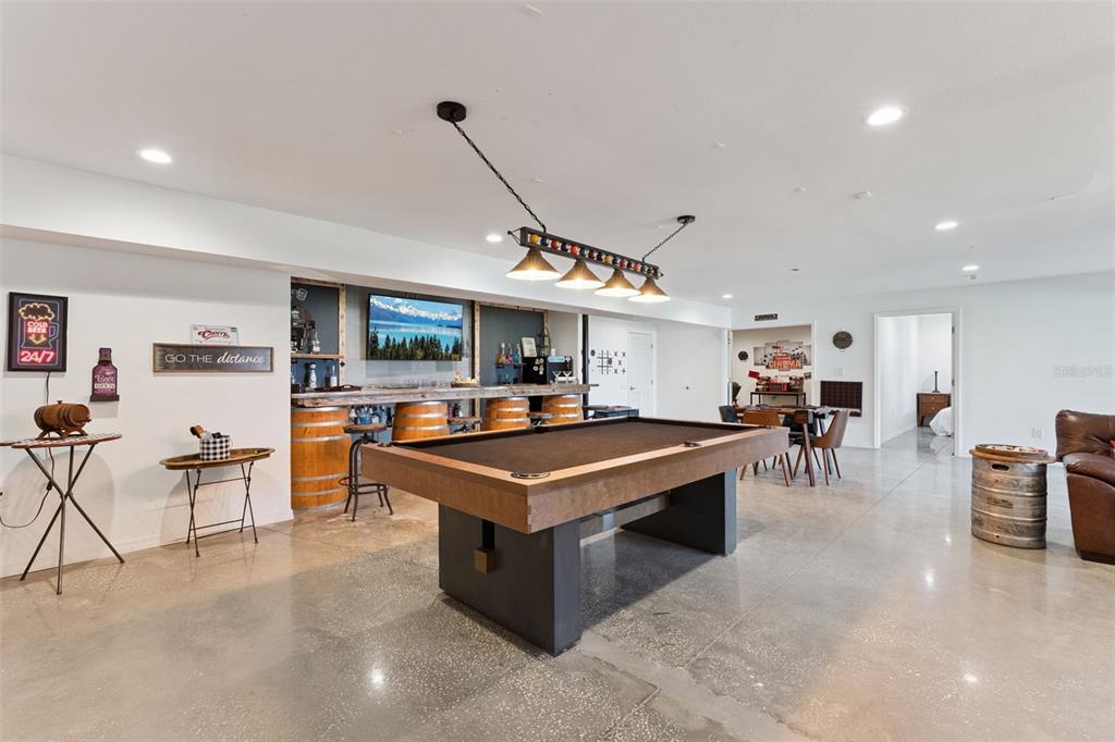 12736 Lake Ridge Circle Clermont, FL 34711 - Photo 37 of 56 a living room with furniture a flat screen tv and a table