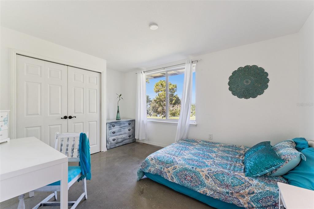 12736 Lake Ridge Circle Clermont, FL 34711 - Photo 47 of 56 a bedroom with a bed and a window