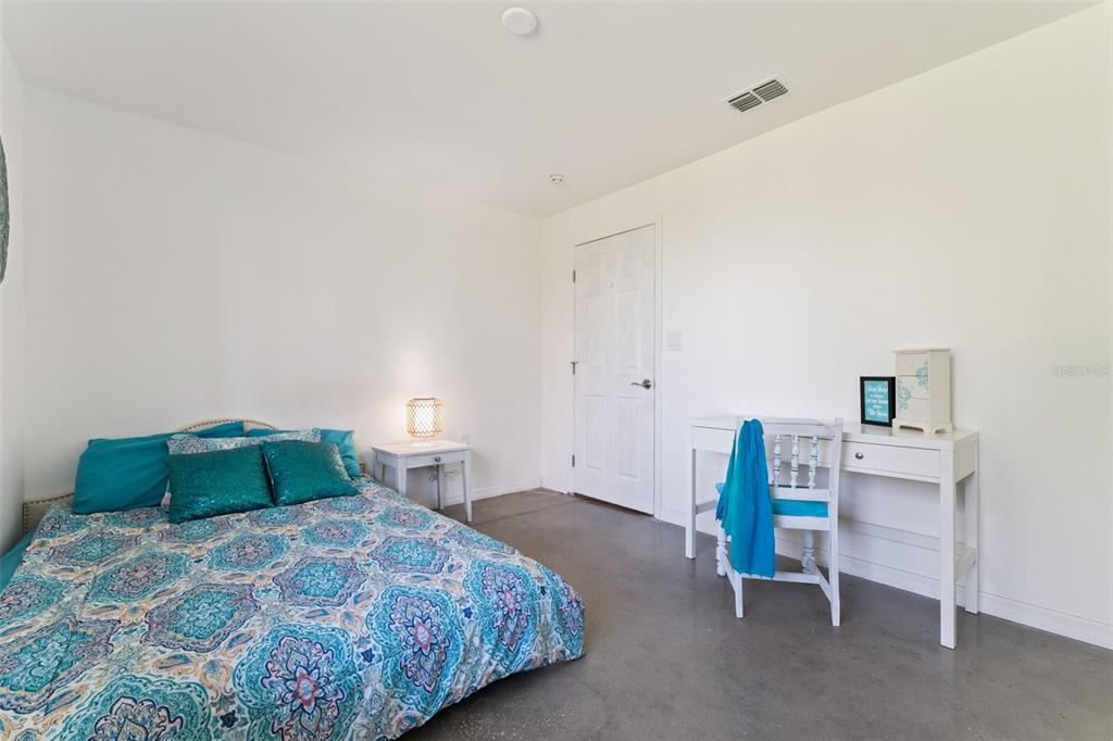 12736 Lake Ridge Circle Clermont, FL 34711 - Photo 48 of 56 a bedroom with a bed and a cabinets