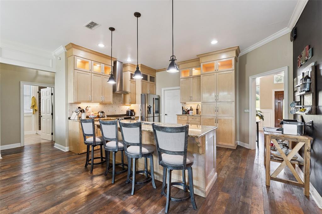 12736 Lake Ridge Circle Clermont, FL 34711 - Photo 5 of 56 a view of a dining room and livingroom with furniture wooden floor a chandelier