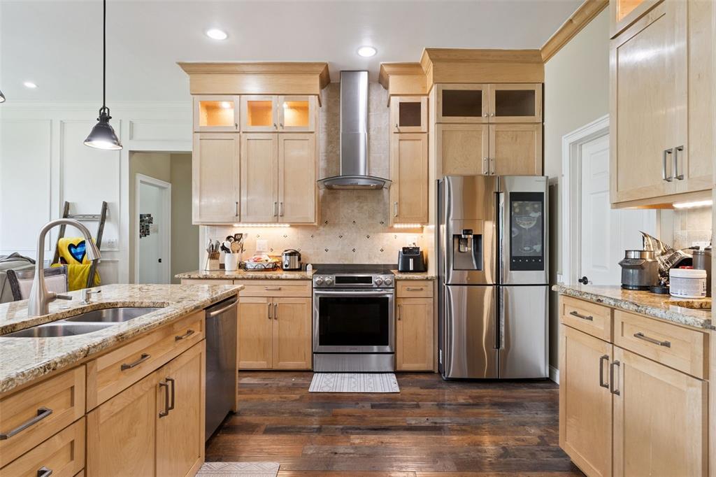 12736 Lake Ridge Circle Clermont, FL 34711 - Photo 7 of 56 a kitchen with stainless steel appliances granite countertop a refrigerator a sink a stove and white cabinets