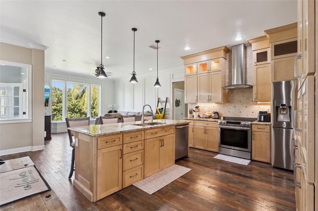 12736 Lake Ridge Circle Clermont, FL 34711 - Photo 8 of 56 a kitchen with stainless steel appliances granite countertop a stove a sink and a refrigerator
