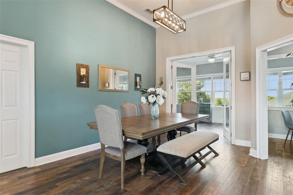 12736 Lake Ridge Circle Clermont, FL 34711 - Photo 10 of 56 a view of a dining room with furniture wooden floor and chandelier