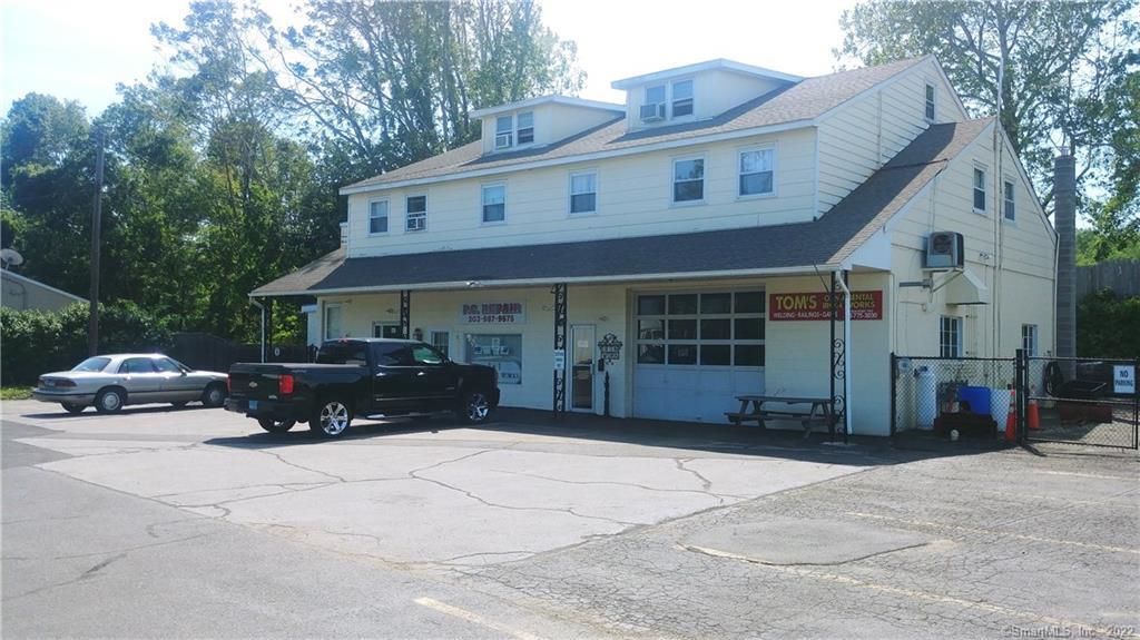 Built by existing owner's father, and continuously occupied since 1967.  Current owner uses half of main ground level light industrial, other half commercial tenant, plus four residential apartments above. All tenants in place!