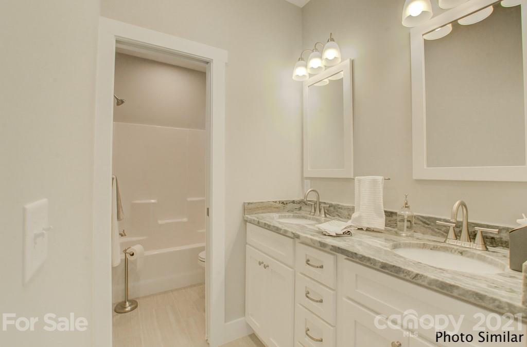 175 Hayes Rdg Lane, Unit 8 Mills River, NC 28759 - Photo 16 of 18 a bathroom with a granite countertop sink and a mirror