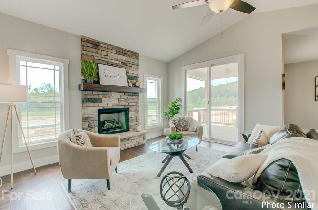 175 Hayes Rdg Lane, Unit 8 Mills River, NC 28759 - Photo 3 of 18 a living room with furniture a fireplace and a floor to ceiling window