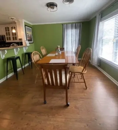 a view of a dining room with furniture window and outside view