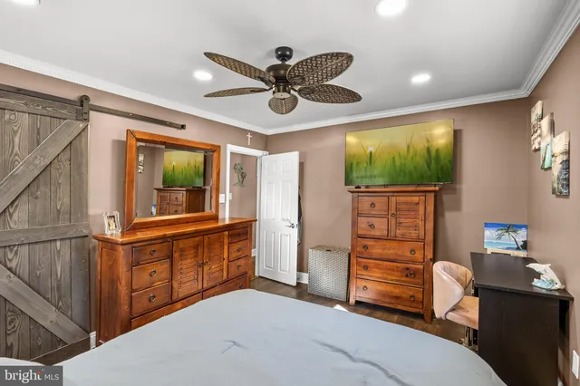 a living room with stainless steel appliances kitchen island granite countertop furniture and a flat screen tv