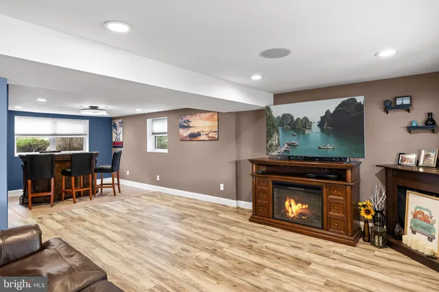 a living room with furniture a fireplace and a flat screen tv