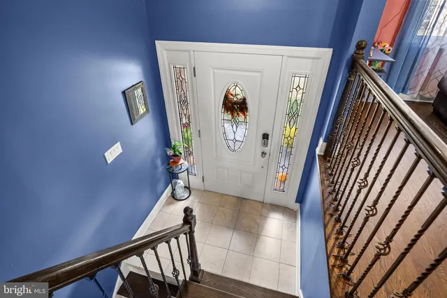 a view of a hallway with wooden floor and stairs