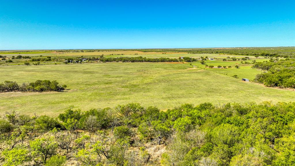 2337 Walsh Road Olney, TX 76374 - Photo 10 of 38 Expansive landscape featuring open grassy fields, diverse tree coverage, and a distant structure