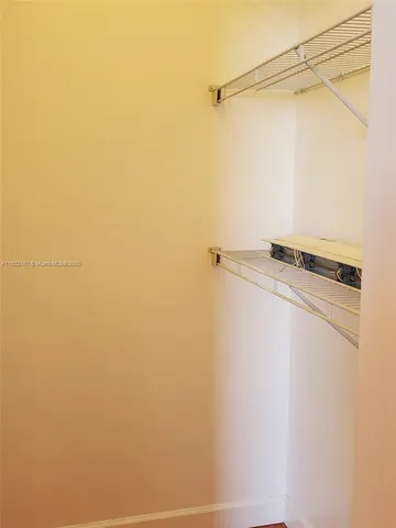 a bathroom with a granite countertop toilet and a sink