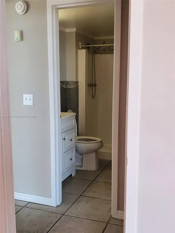 a bathroom with a shower and a glass door