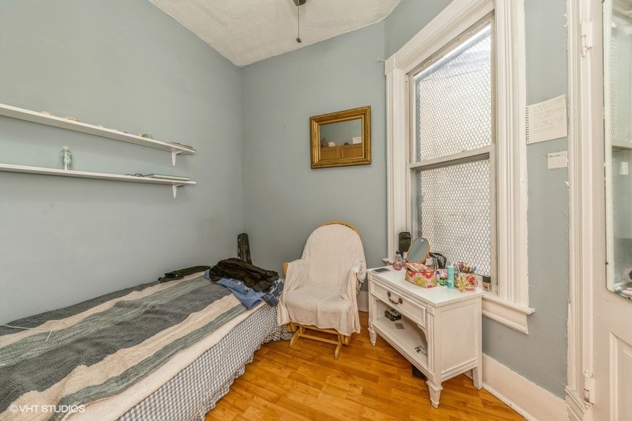 2347 West Maypole Avenue Chicago, IL 60612 - Photo 15 of 20 a bedroom with a bed and a window