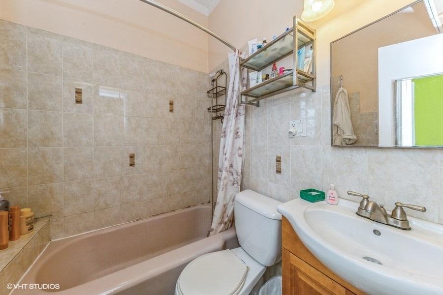 2347 West Maypole Avenue Chicago, IL 60612 - Photo 16 of 20 a bathroom with a sink a toilet and shower