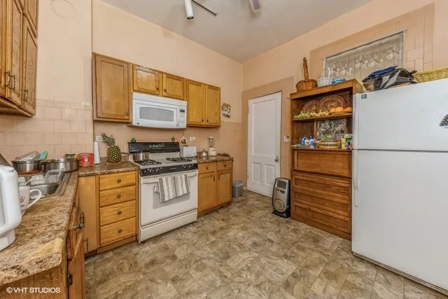 a kitchen with stainless steel appliances a refrigerator and a stove