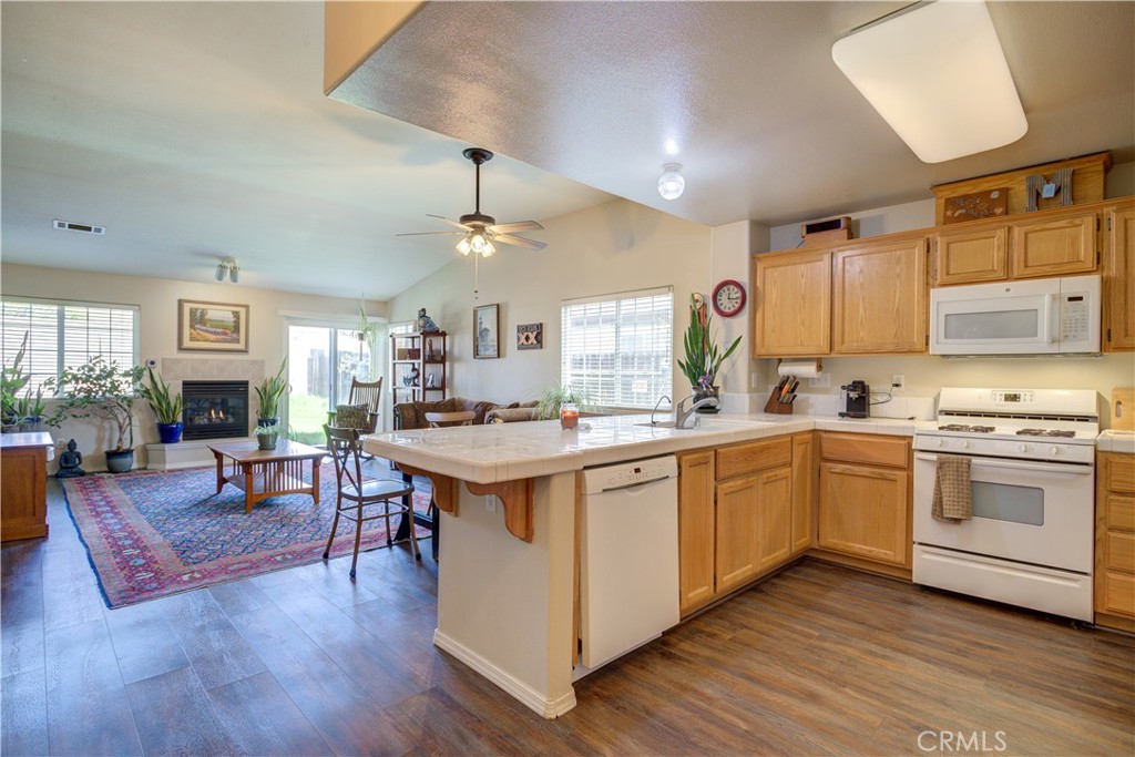 a open kitchen with cabinets a sink and appliances