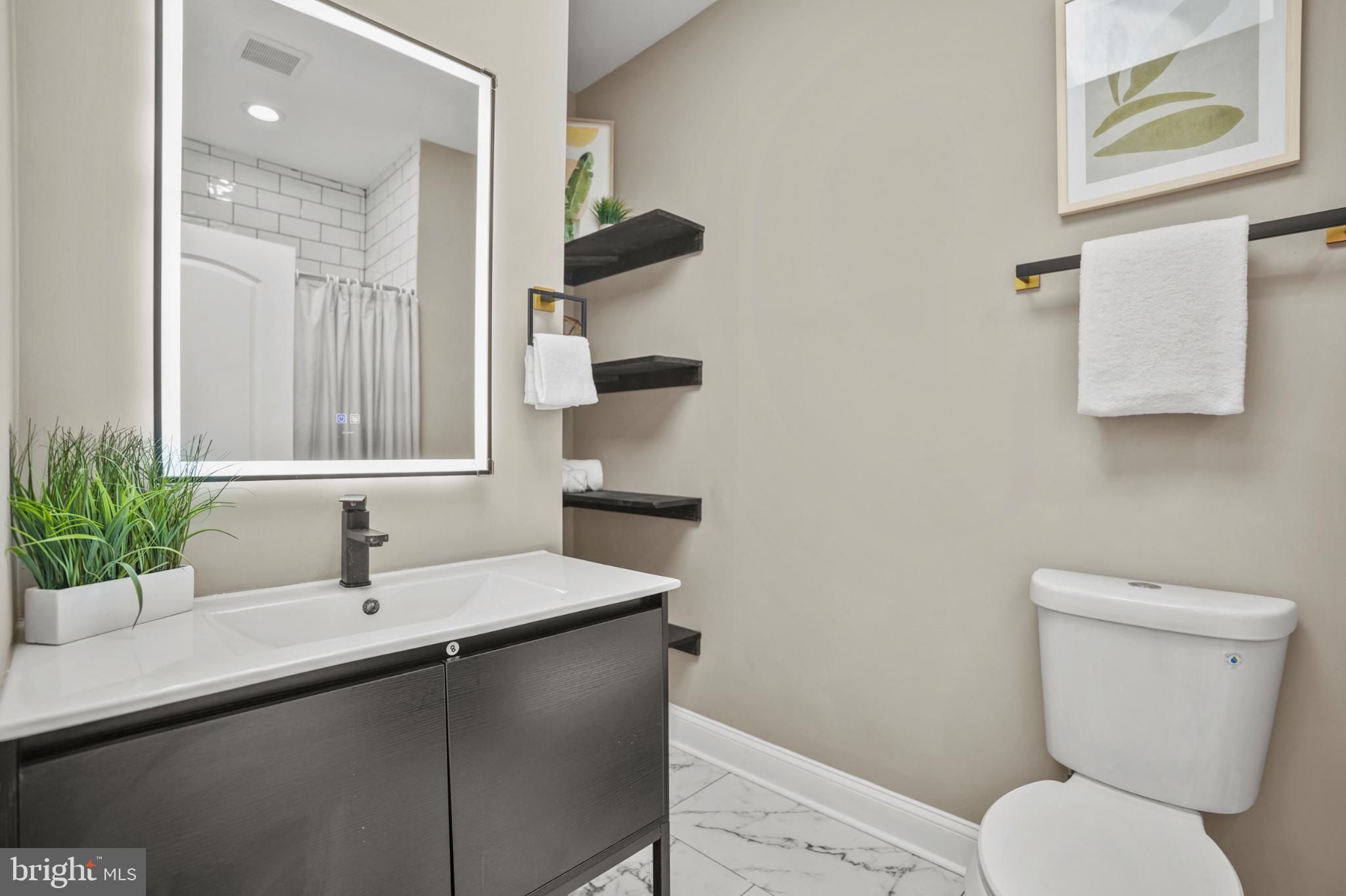 1714 East 28th Street Baltimore, MD 21218 - Photo 17 of 27 Sleek modern bathroom with elegant touches.
