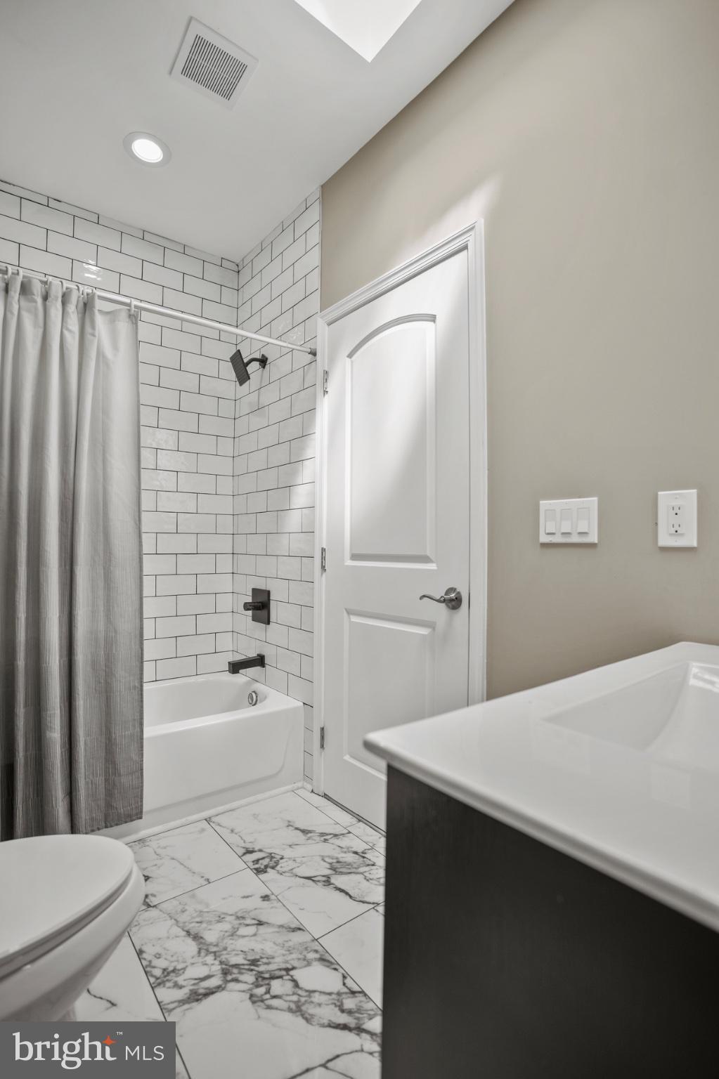 1714 East 28th Street Baltimore, MD 21218 - Photo 19 of 27 Sleek modern bathroom with elegant tiles.