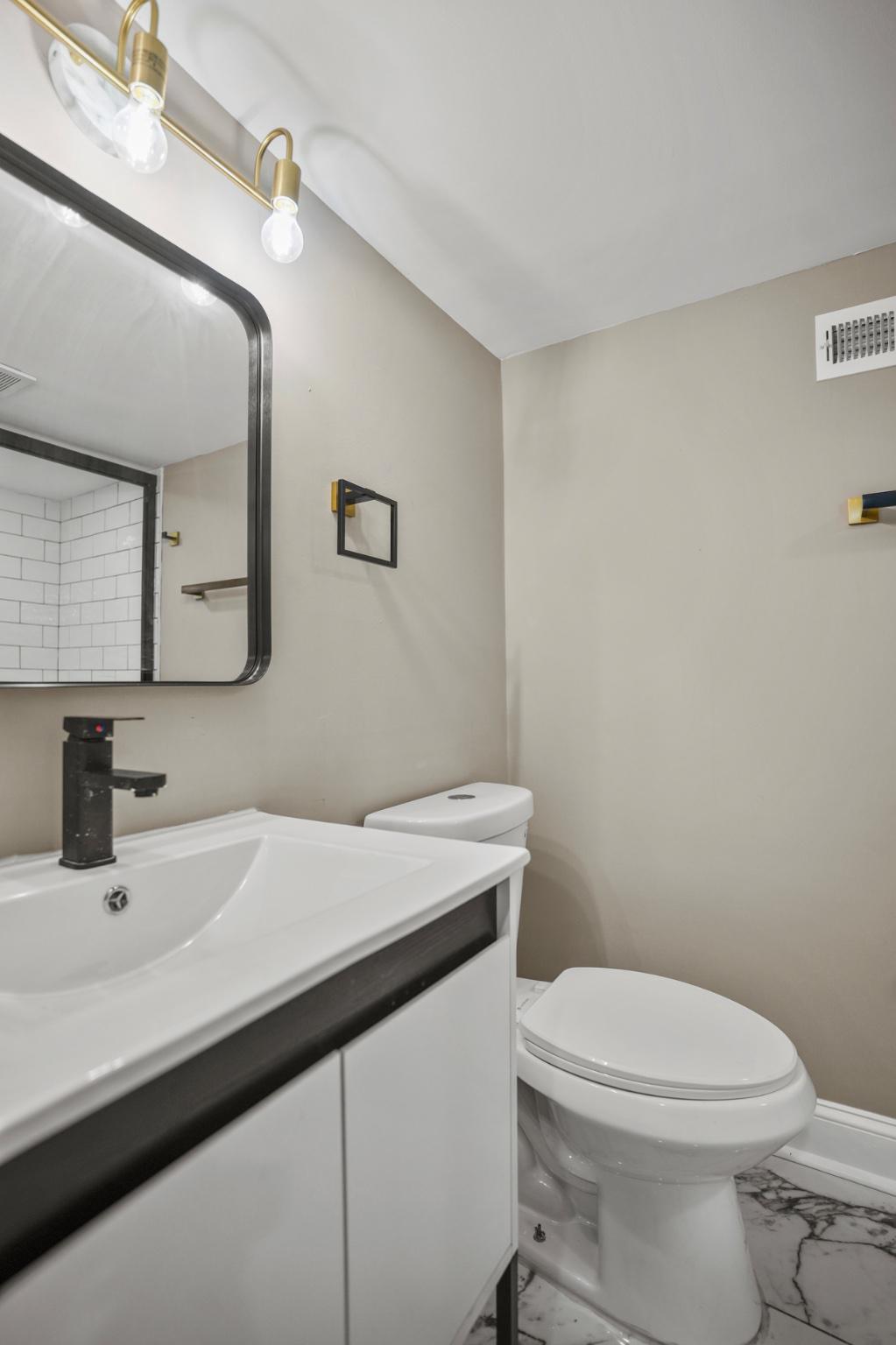 1714 East 28th Street Baltimore, MD 21218 - Photo 26 of 27 Sleek modern bathroom with elegant fixtures.