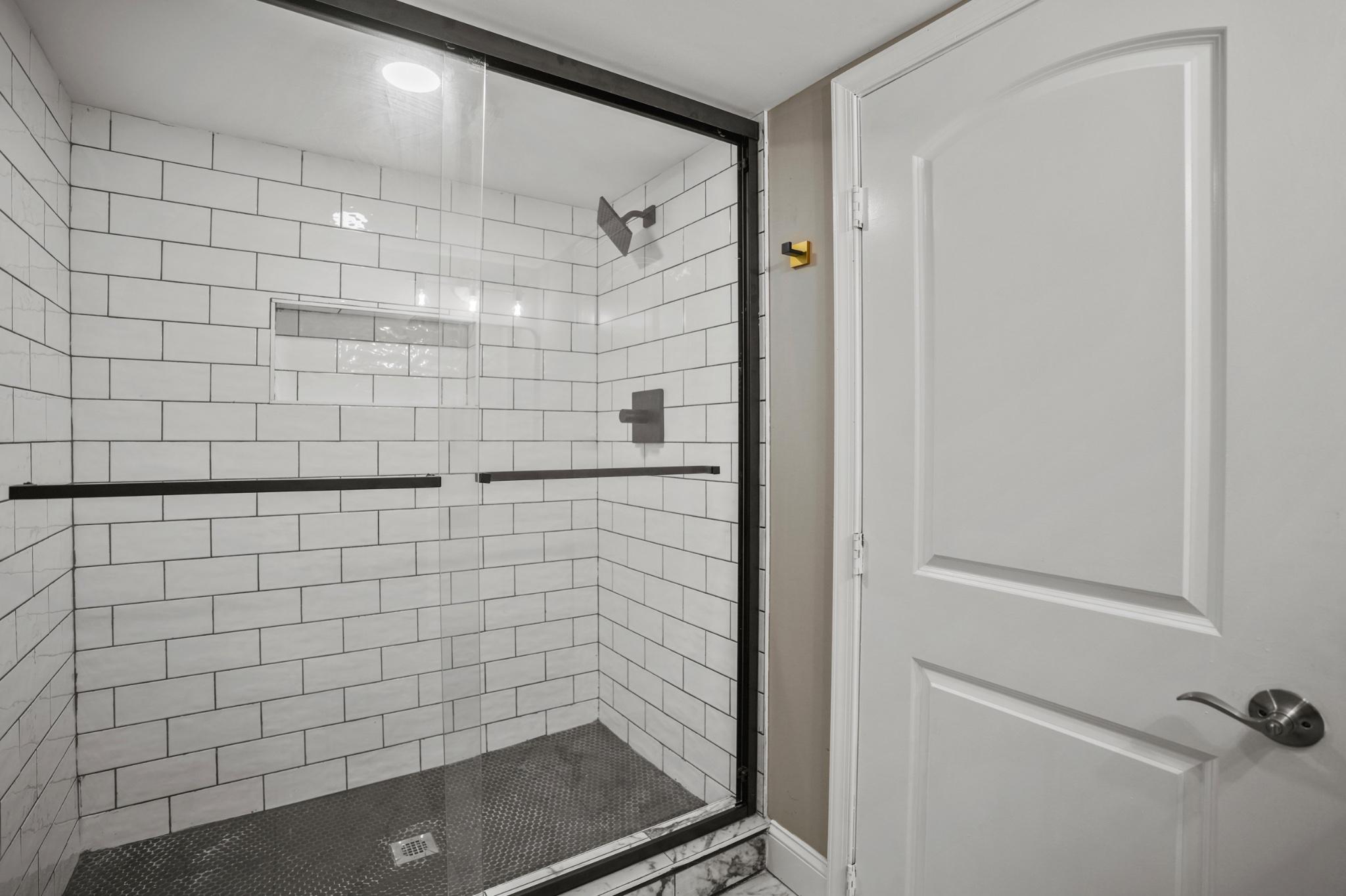 1714 East 28th Street Baltimore, MD 21218 - Photo 27 of 27 Sleek modern shower with elegant tiles.
